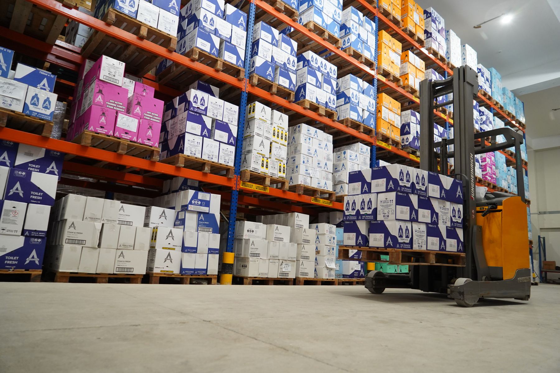 Racked stock and a reach truck inside a Tarseel warehouse
