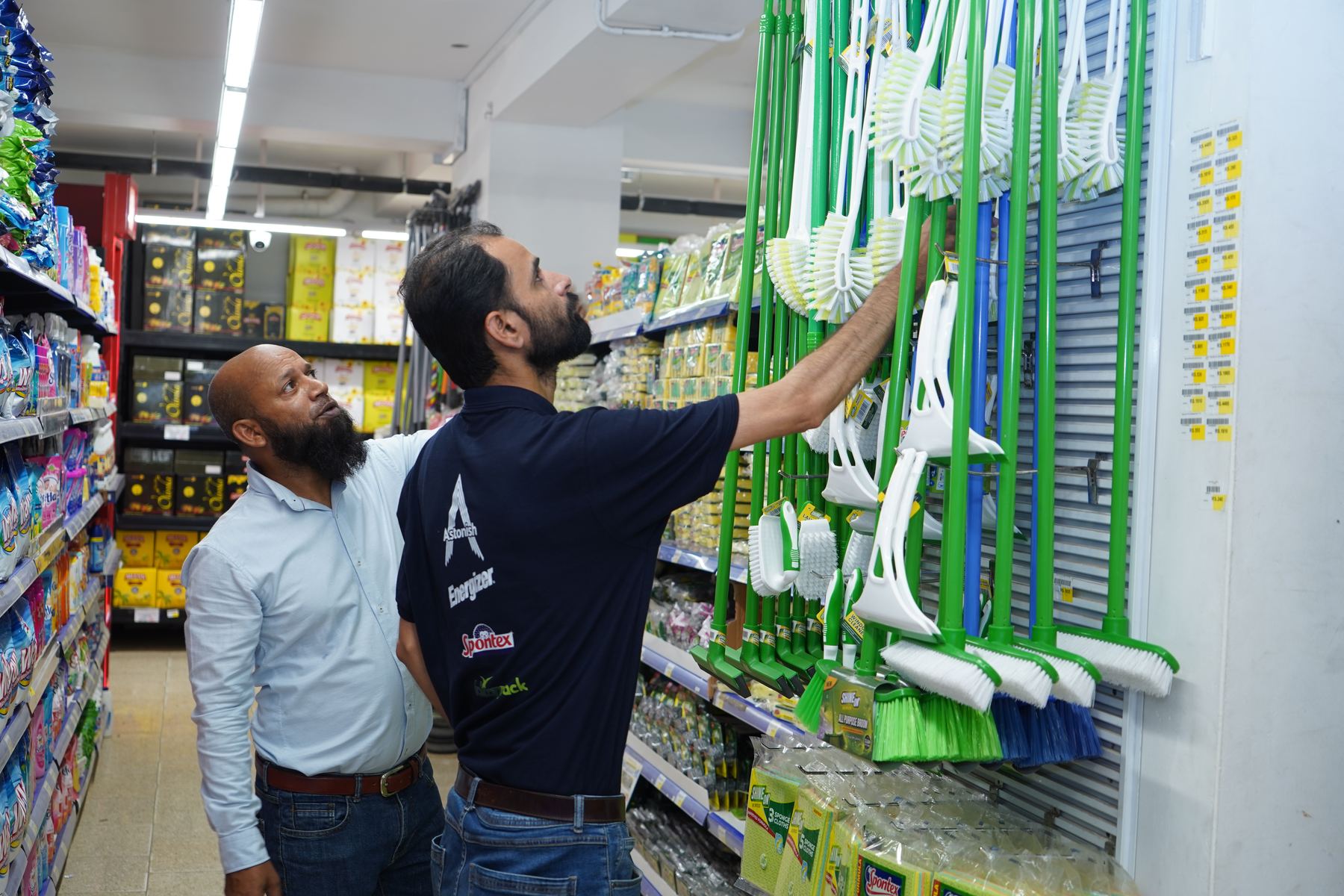Tarseel merchandiser setting up a Shine On display in store