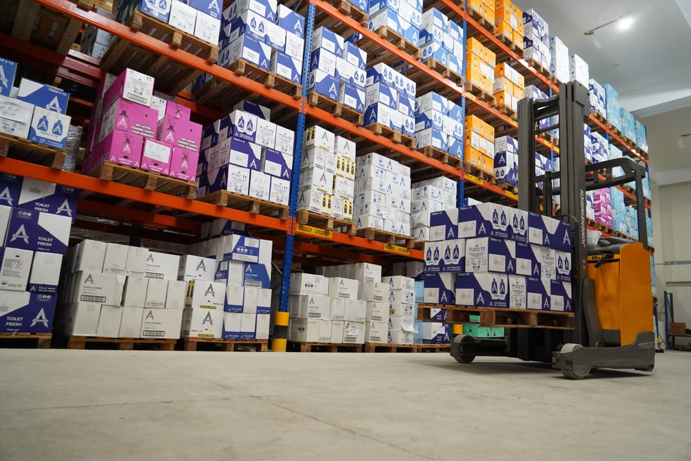 Reach truck moving a pallet of Astonish stock
